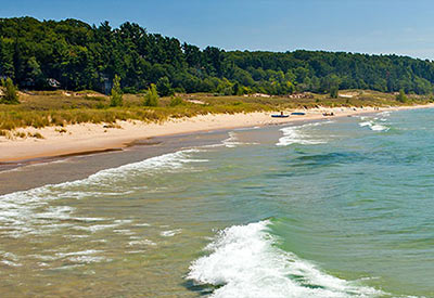 sand beach with waves on summer day