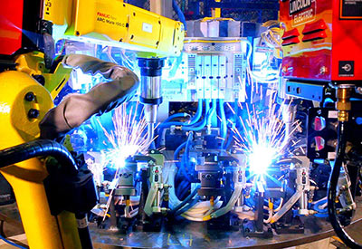 two industrial robots welding and sparks flying