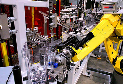 yellow industrial robot assembles blender