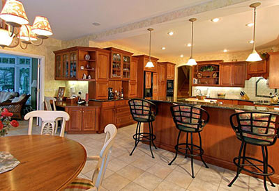 wide shot of modern kitchen with bar stools