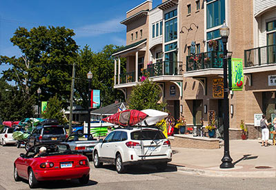 downtown Pentwater with shops and cars on summer day