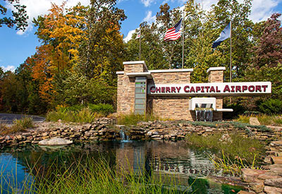 entrance sign with waterfall that says Cherry Capital Airport